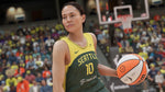 Basketball player holding a ball in a stadium with fans in the background. From the game NBA 2K23 for PlayStation 5.