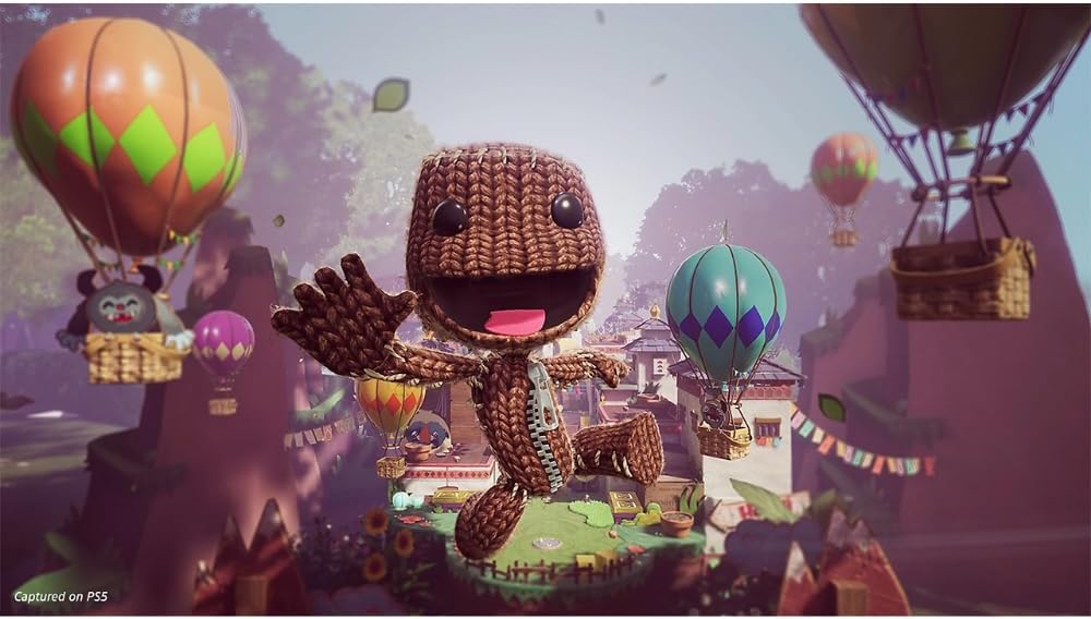 A stylized scene featuring the character Sackboy in the center, surrounded by colorful hot air balloons and a whimsical landscape. The image appears to be promotional artwork or a digital game scene rather than a straightforward product photo.