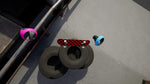 Two small tires with colorful rims on a concrete surface. From the game VR Skater for PlayStation 5.