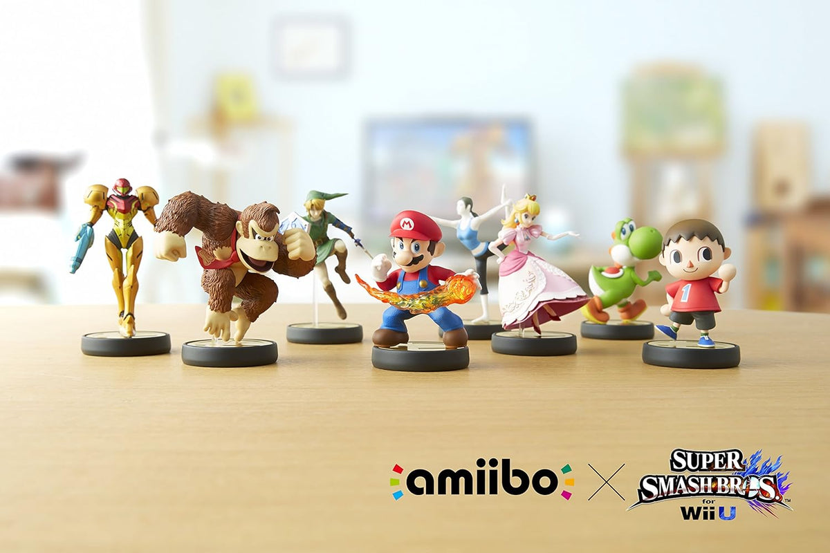 Collection of amiibo figures on a table with 'amiibo' and 'Super Smash Bros.' logos.