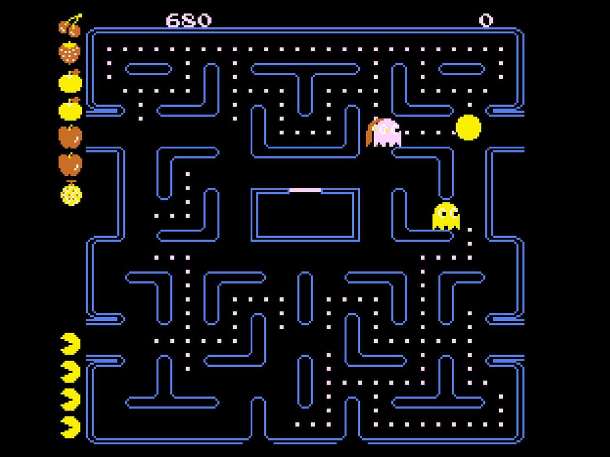 Atari 2600+ Pac-Man Double Feature gameplay screenshot showing a classic blue maze with Pac-Man, colourful ghosts, pellets and retro arcade graphics.