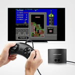 AtGames Legends Flashback retro console connected to a television displaying a classic arcade game, with a player holding one of the included wired controllers.