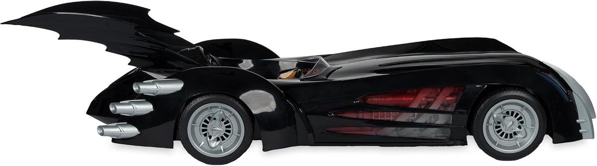 Rear side view of the Batman and Robin Batmobile showing the large bat wing, triple exhausts and red side detailing