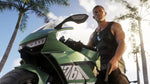 Main character Jason in a black vest sitting on a green motorbike beneath palm trees in Vice City.