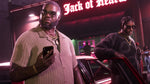 Two men standing beside a car outside a building illuminated by pink neon lights in GTA 6 Vice city.