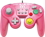 HORI Princess Peach Battle Pad wired controller for Nintendo Switch, front view showing its pink GameCube-style design, Princess Peach artwork, grey D-pad and colourful buttons.