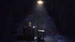 Little Nightmares Enhanced Edition PS5 gameplay showing Six standing on a raised platform beneath a spotlight inside a dark, mysterious chamber.