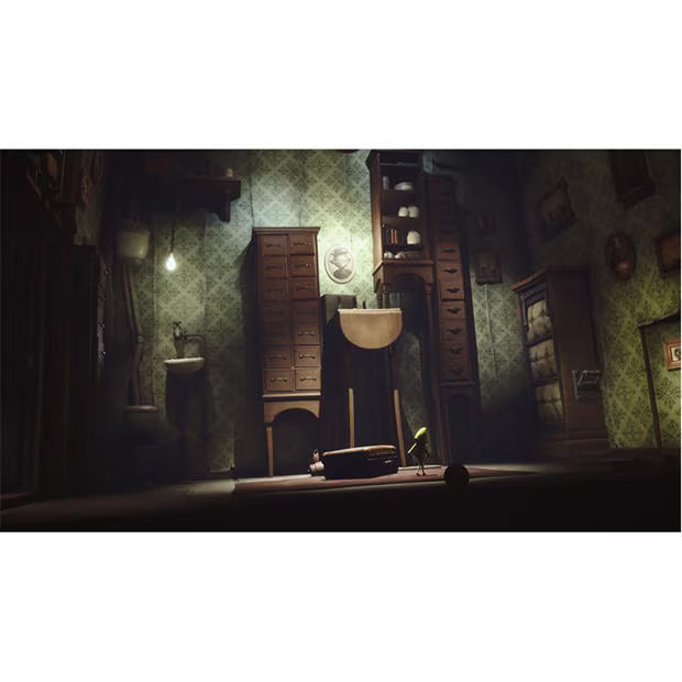 Little Nightmares Enhanced Edition PS5 gameplay showing a creepy, dimly lit room with old furniture, towering cupboards and atmospheric horror lighting.