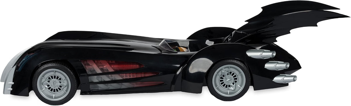 Side profile of the McFarlane Batman and Robin Batmobile showing its black body, rear bat fins and silver wheels
