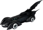 Side profile of the McFarlane Batman Forever Batmobile showing its long black body, bat fins and Batman wheel emblems