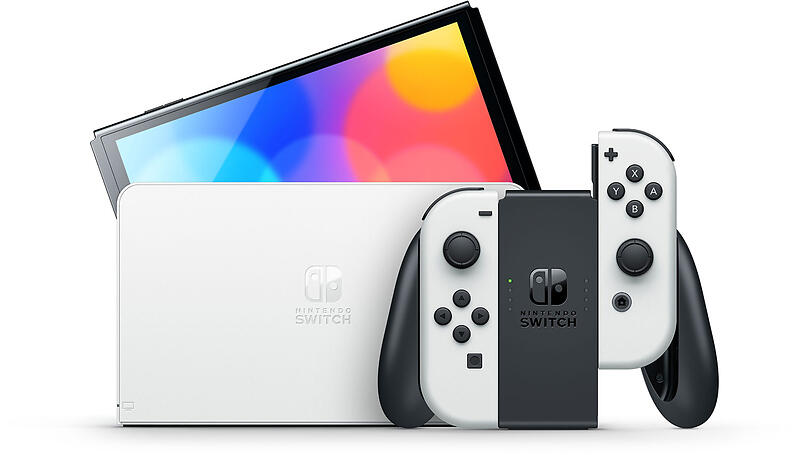 Nintendo Switch OLED Model in White displayed with its matching TV dock and Joy-Con controllers, showing the console screen and included accessories.