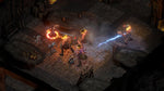 Pillars of Eternity II Deadfire Xbox One combat screenshot showing characters battling enemies in a stone dungeon using fiery magic and blue lightning attacks.