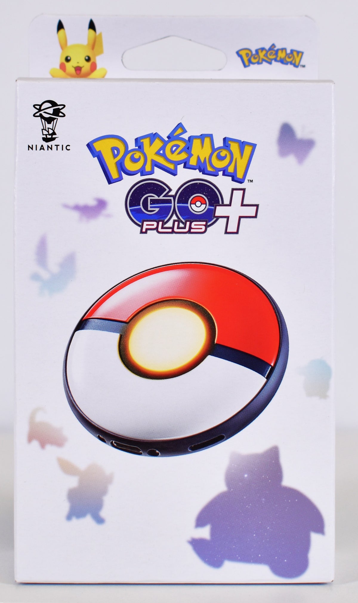 Pokémon GO Plus + official retail packaging featuring the Poké Ball-inspired Bluetooth accessory, Pokémon GO branding and colourful Pokémon silhouettes.