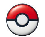 Pokémon GO Plus + Bluetooth accessory shown from the front, featuring its red and white Poké Ball design, central illuminated button and black detailing.