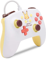 PowerA Pokémon Pikachu Electric Type Enhanced Wired Controller for Nintendo Switch in a three-quarter front view, featuring Pikachu graphics, a white USB cable and yellow side grips.