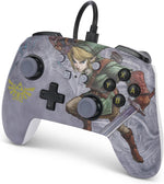 PowerA Valiant Link Enhanced Wired Controller shown from a raised front angle, featuring detailed Legend of Zelda artwork, a gold Hylian Crest and grey analogue sticks.