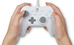 PowerA Officially Licensed White Wired Nintendo Switch Controller held in both hands, demonstrating its comfortable ergonomic grips, thumbstick placement and button layout.