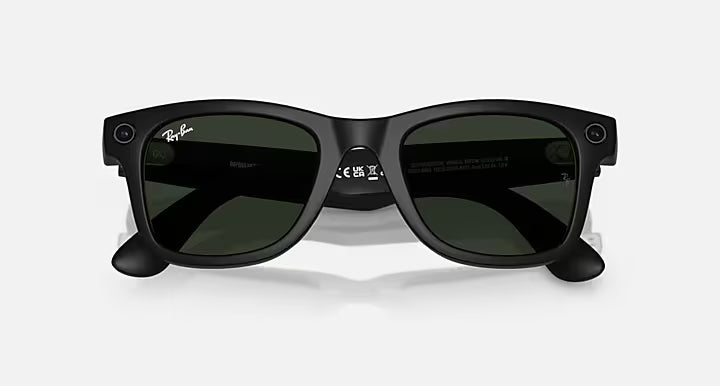 Ray-Ban Meta Wayfarer Smart Glasses in Matte Black showing the Transitions lenses darkened to green, with integrated cameras and classic Wayfarer styling.