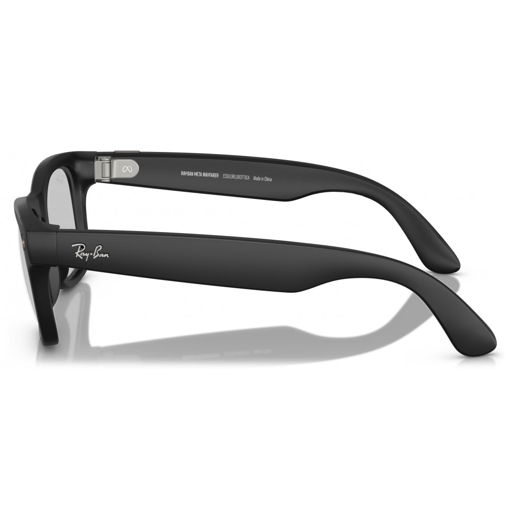 Ray-Ban Meta sunglasses with matte black frames and temples, featuring the Ray-Ban logo on the side, shown on a reflective white surface.
