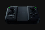 Razer Junglecat dual-sided wireless controller in black, featuring detachable gaming controls, a central grip and green illuminated accents.