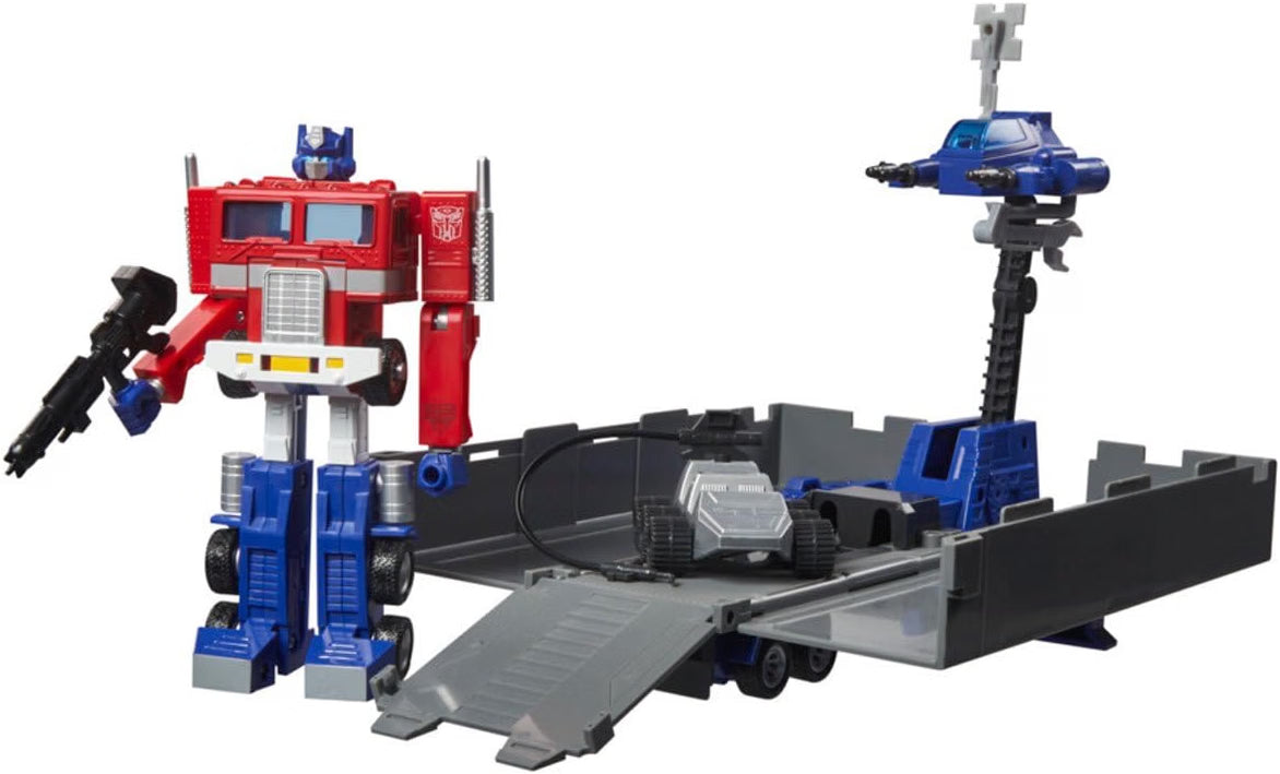 Transformers G1 Optimus Prime robot figure displayed beside the opened trailer with Roller and repair drone