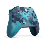 Microsoft Xbox Mineral Camo Special Edition wireless controller shown from a left angle, highlighting its blue camouflage finish, sculpted grips and Xbox gaming controls.