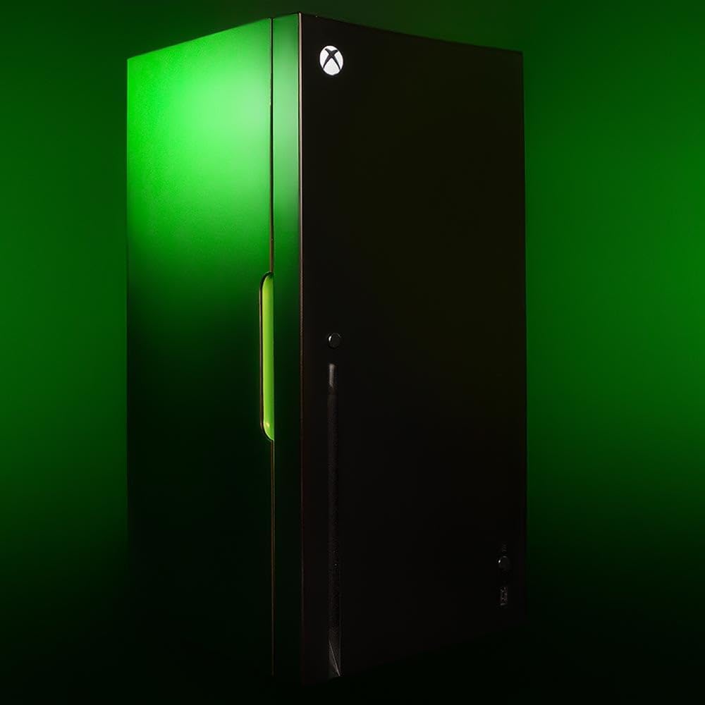 Closed black Xbox replica drinks cooler against a green-lit background, with its Xbox logo illuminated
